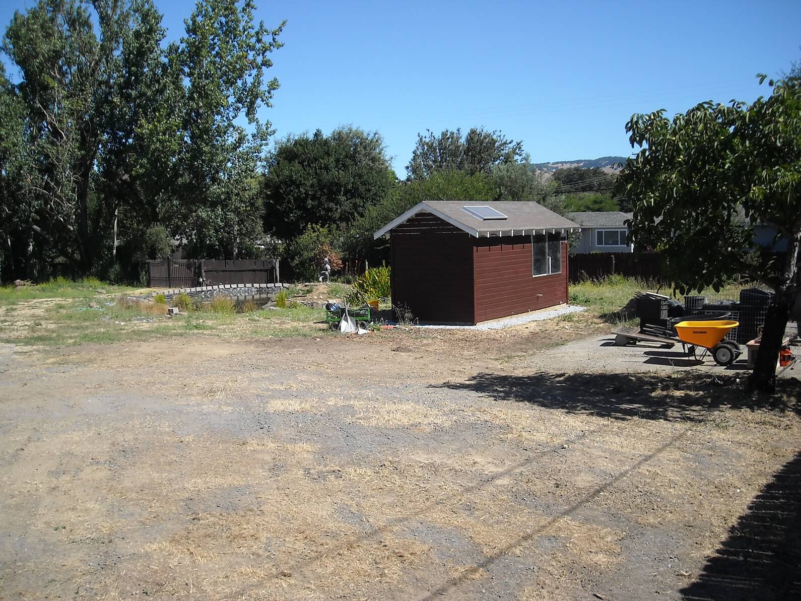 August 2019. The well house, newly painted, and a lot of bare ground.